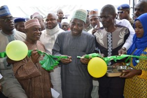 The Speaker, Kwara State House of Assembly, Rt. Hon. Dr. Ali Ahmad cutting the tape to commission the newly established hospital while Commissioner for Health, Alhaji Sulaiman Atolagbe Alege and President of Isale Asa Development Association, Mr. Raji Tunde and others watch. 