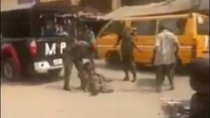 soldiers torturing physically challenged man